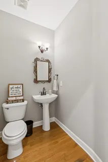 a bathroom with a sink toilet and a mirror