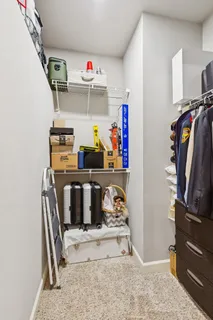 a view of walk in closet with clothes and shoes