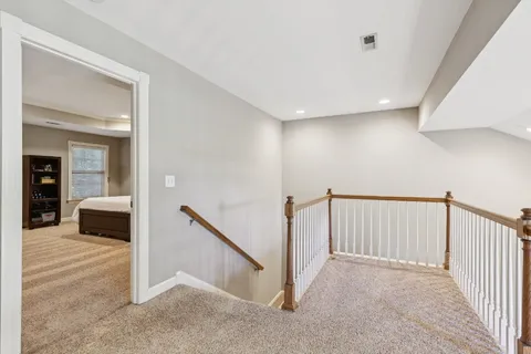a bedroom with a large bed and a flat tv screen