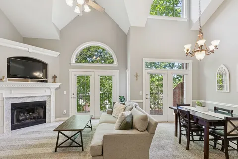 a living room with furniture a fireplace and a flat screen tv