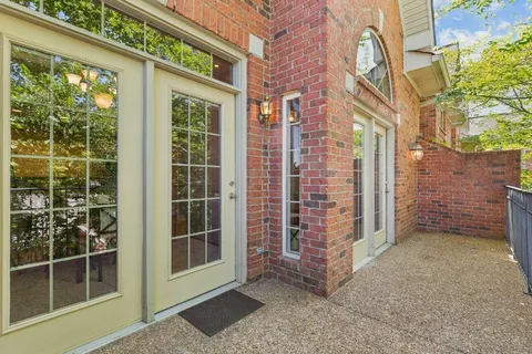 a view of a brick house with a large window