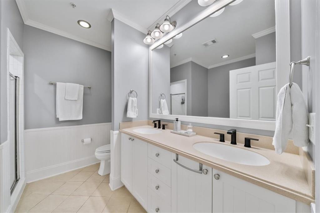 4100 Paces Walk Southeast, Unit 1101 Atlanta, GA 30339 - Photo 17 of 36 a bathroom with a double vanity sink mirror and toilet