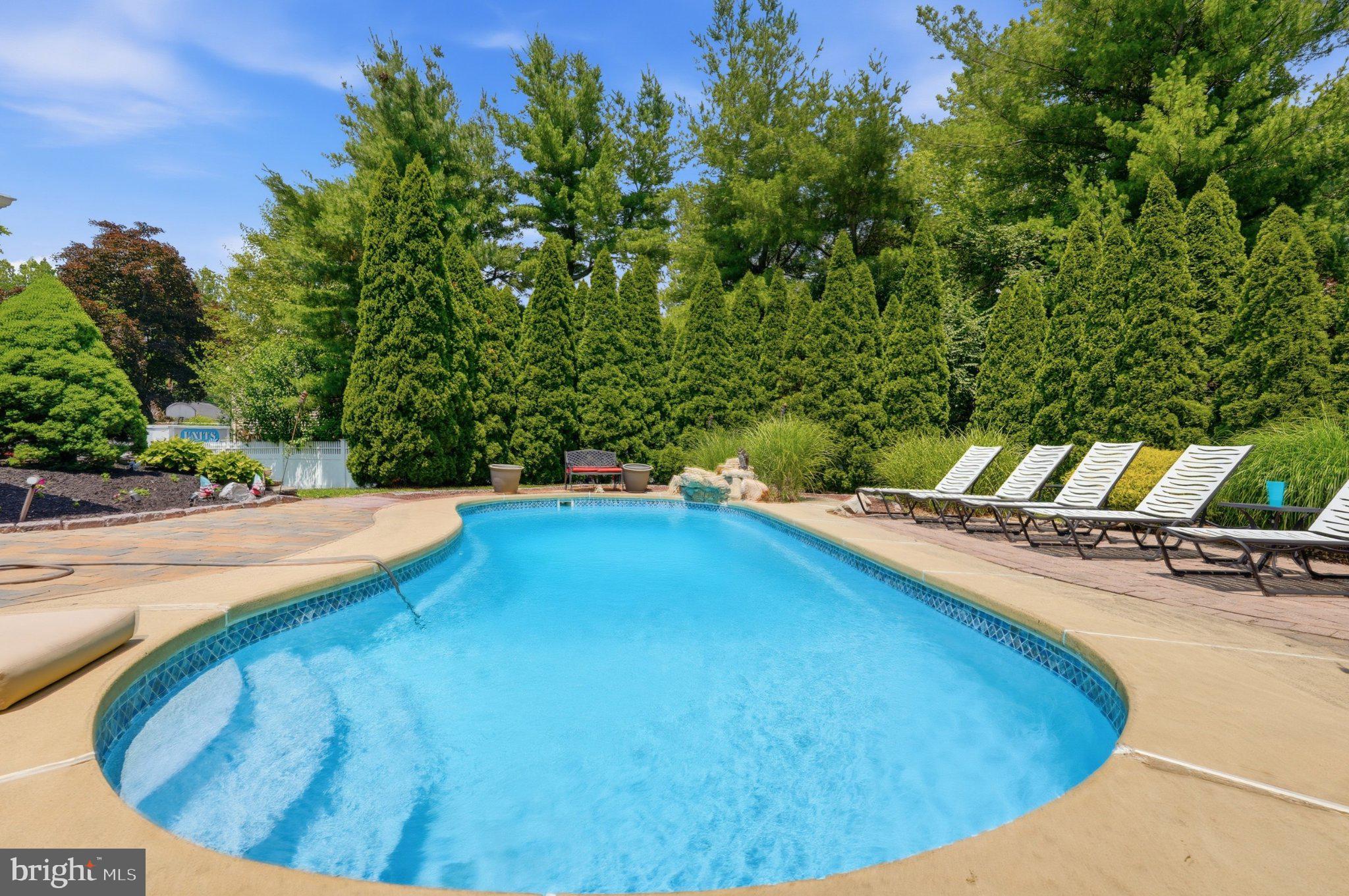 1002 Tannerie Run Road Ambler, PA 19002 - Photo 6 of 67 Serene poolside retreat in lush greenery.