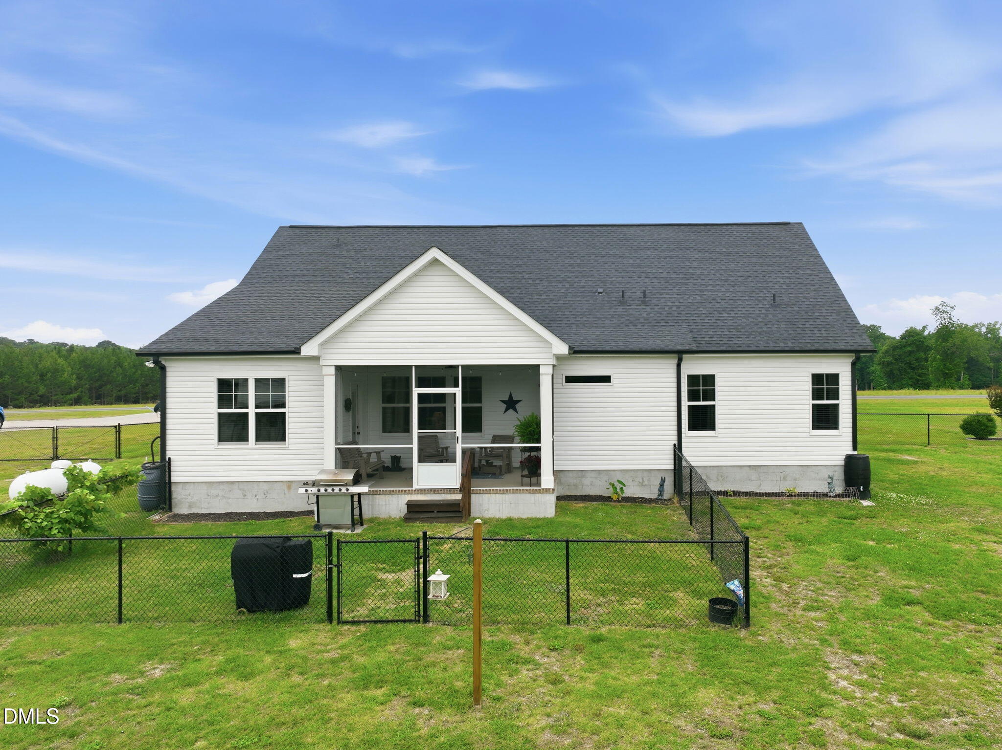 5098 Spring Hill Church Road Lillington, NC 27546 - Photo 33 of 36 a front view of house with a garden and plants