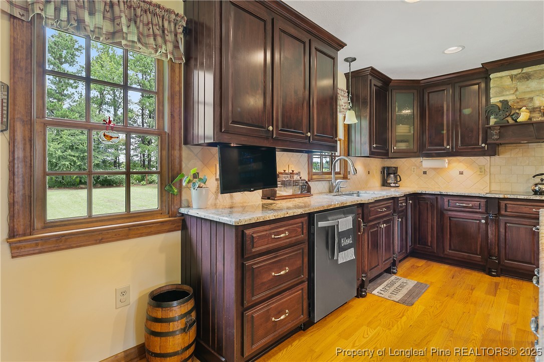 5017 Goldsboro Road Wade, NC 28395 - Photo 13 of 50 a kitchen with stainless steel appliances granite countertop wooden cabinets a sink and dishwasher