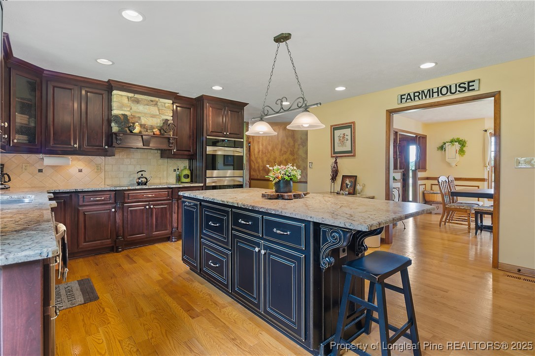 5017 Goldsboro Road Wade, NC 28395 - Photo 14 of 50 a kitchen with a table chairs sink and wooden floor