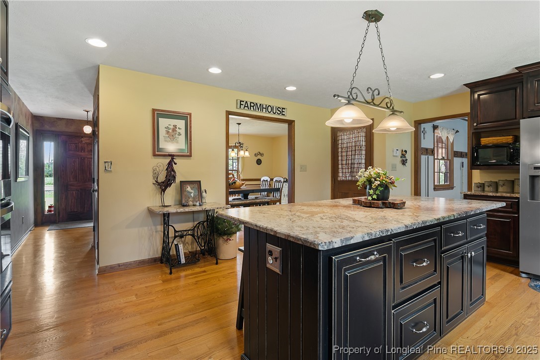 5017 Goldsboro Road Wade, NC 28395 - Photo 15 of 50 a kitchen with a counter space appliances and wooden floor