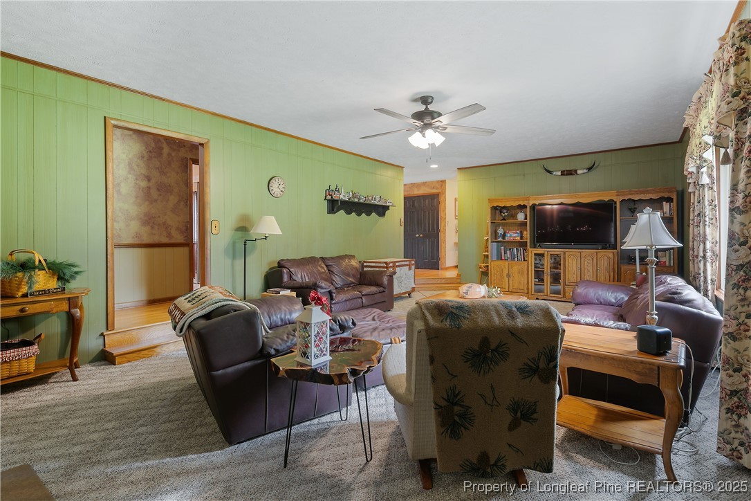 5017 Goldsboro Road Wade, NC 28395 - Photo 22 of 50 a living room with furniture a flat screen tv and wooden floor