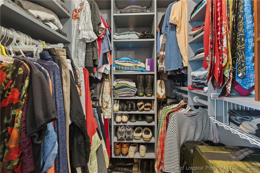 5017 Goldsboro Road Wade, NC 28395 - Photo 32 of 50 a view of walk in closet with clothes and shoes