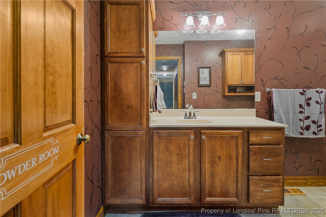 5017 Goldsboro Road Wade, NC 28395 - Photo 36 of 50 a bathroom with a sink a mirror and a shower