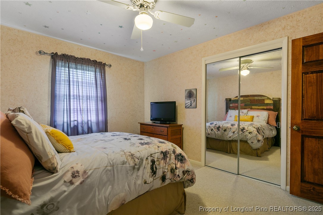 5017 Goldsboro Road Wade, NC 28395 - Photo 39 of 50 a bedroom with a bed and ceiling fan