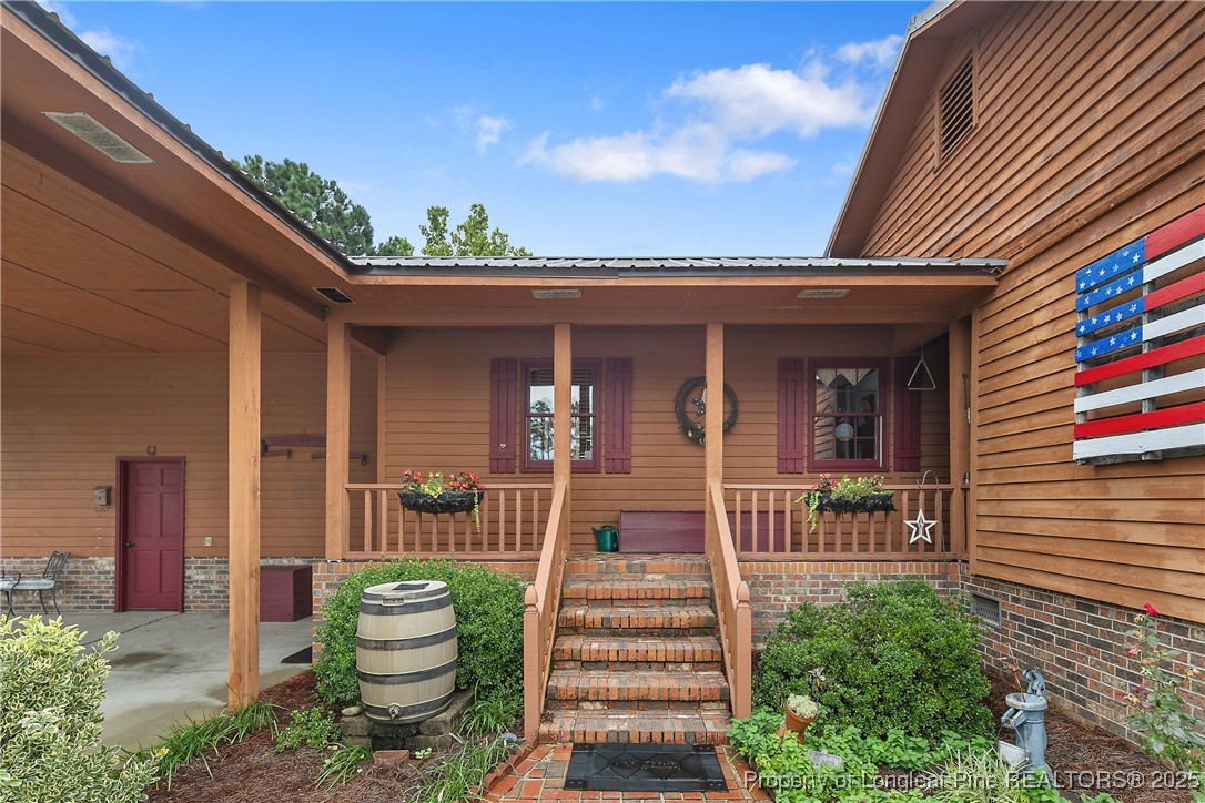 5017 Goldsboro Road Wade, NC 28395 - Photo 4 of 50 a front view of a house with a porch
