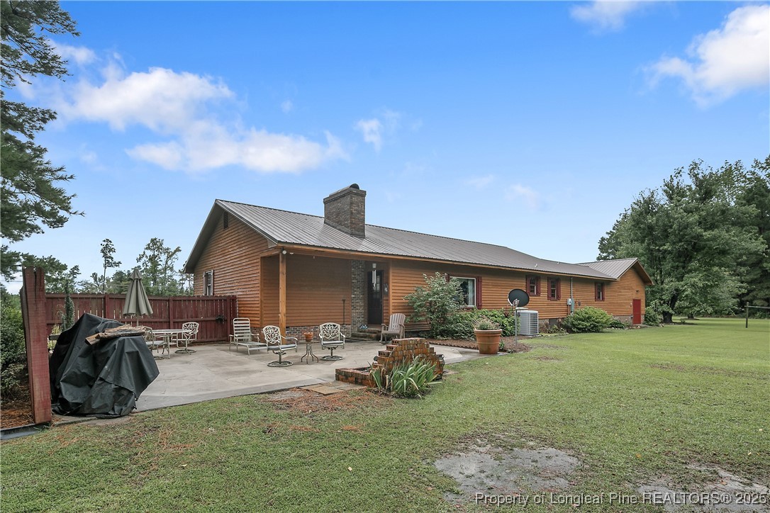 5017 Goldsboro Road Wade, NC 28395 - Photo 43 of 50 a view of a patio with table and chairs under an umbrella