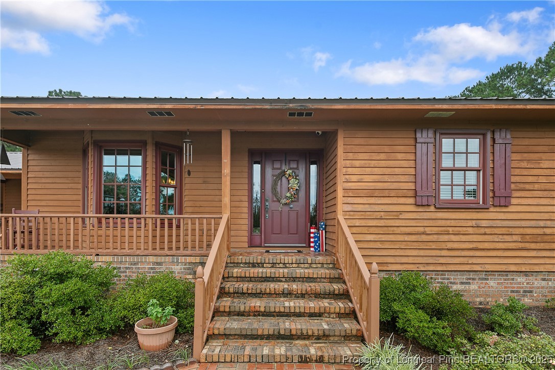 5017 Goldsboro Road Wade, NC 28395 - Photo 5 of 50 a view of a house with plants and wooden fence