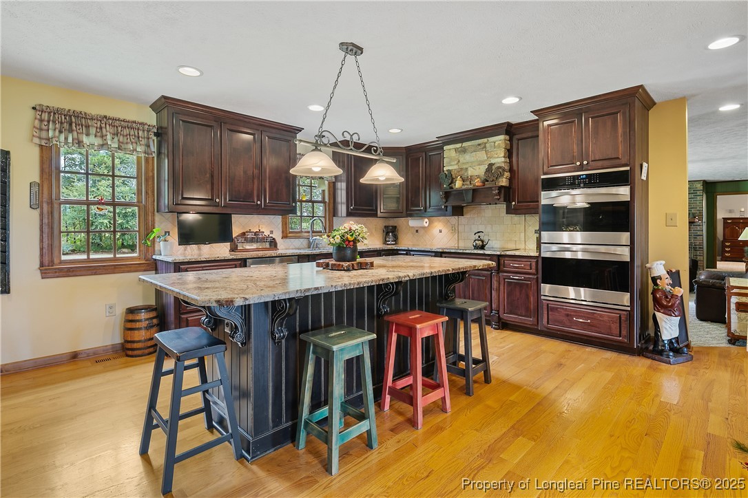 5017 Goldsboro Road Wade, NC 28395 - Photo 10 of 50 a kitchen with a table chairs sink and cabinets