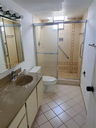 a view of a backyard with plants and a garden