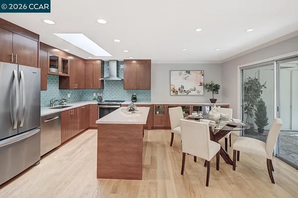 a large kitchen with a large counter top appliances and cabinets