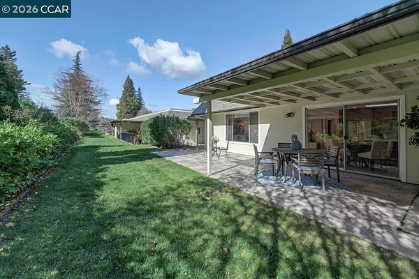 a view of a house with backyard porch and sitting area