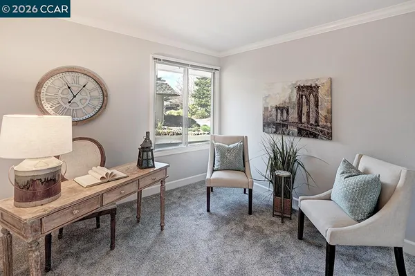 a living room with furniture and a chair