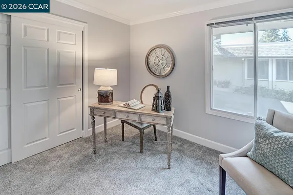 a view of a room that has a window and a chair