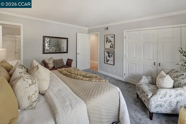 a bedroom with a bed and a couch