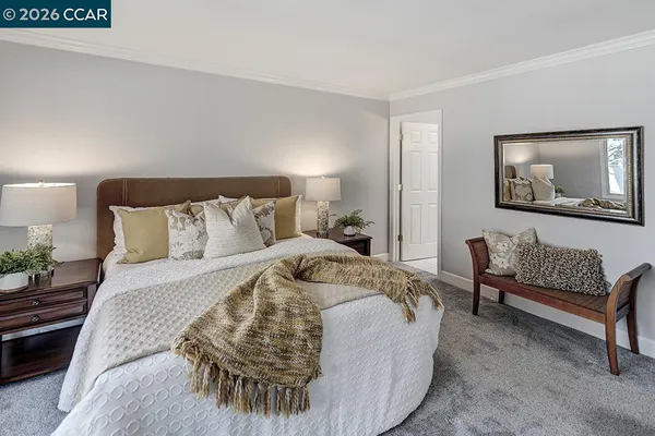 a bedroom with a bed and a couch
