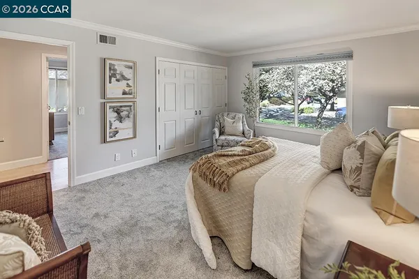 a bedroom with a bed and a window