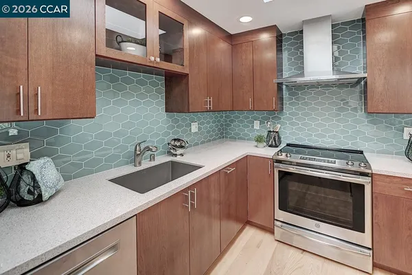 a kitchen with a sink cabinets and stainless steel appliances