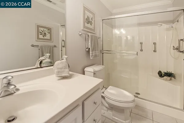 a bathroom with a double vanity sink mirror and toilet