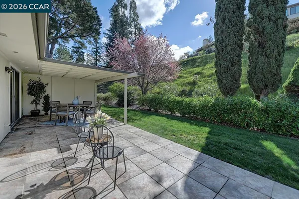 a view of a backyard with sitting area
