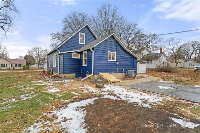a view of a house with a yard covered in snow