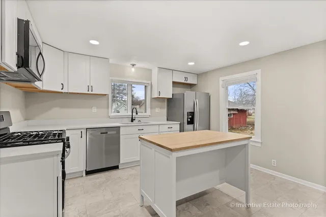 a kitchen with a sink stove and refrigerator