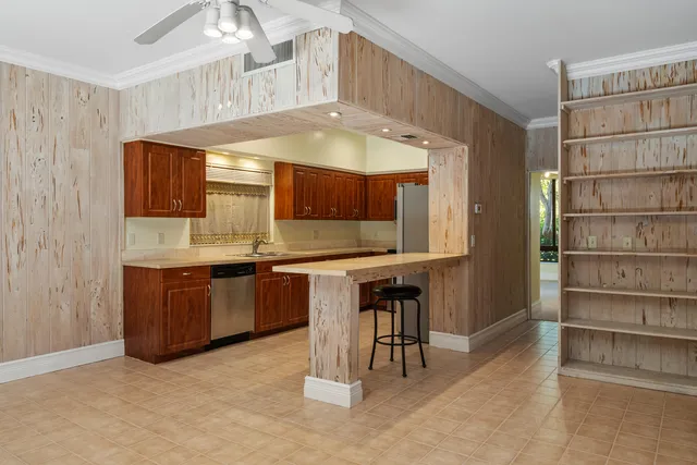 a kitchen with granite countertop a sink and cabinets