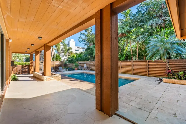 a view of porch with a floor to ceiling window next to a yard