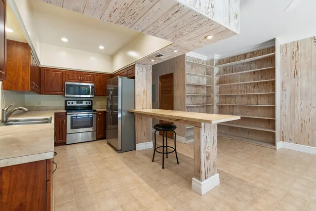 a kitchen with cabinets and stainless steel appliances