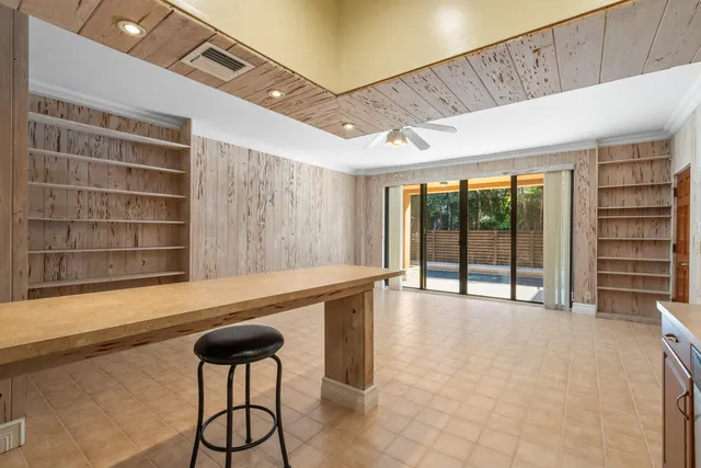 a view of an empty room with a window and chair