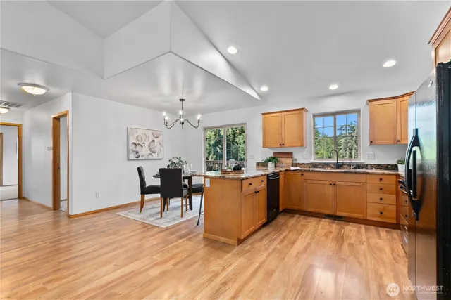 a large kitchen with a table and chairs in it