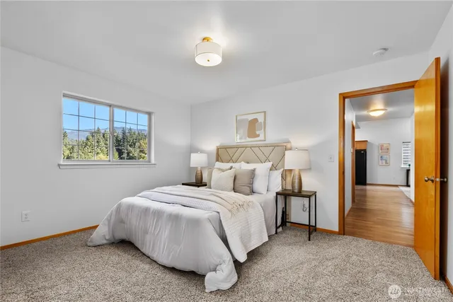 a bedroom with a bed and a painting on the wall