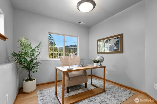 a workspace with furniture and a potted plant
