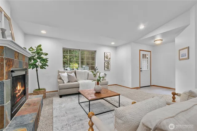 a living room with furniture and a fireplace