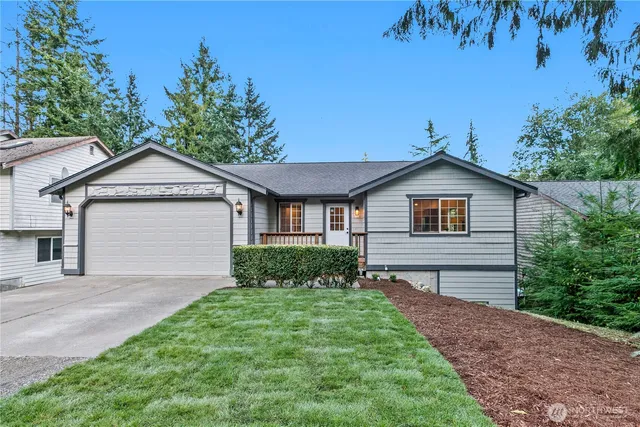 a front view of a house with a yard and garage