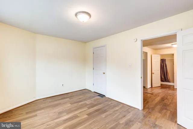 a view of a room with wooden floor