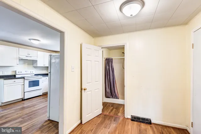 a view of a kitchen from the hallway