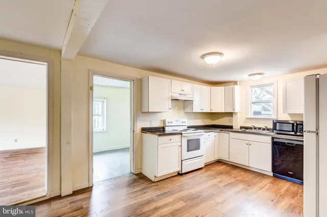 a kitchen with a stove a sink and a refrigerator