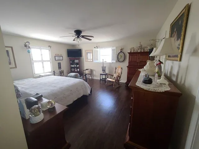 a view of a hallway with wooden floor and stairs