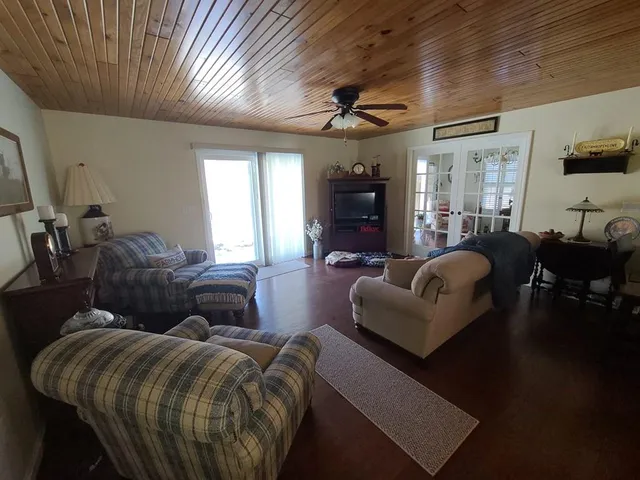 a living room with furniture and a chandelier