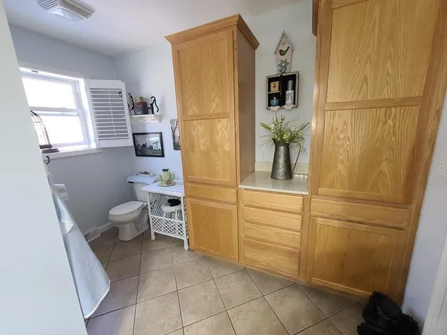 a bathroom with a double vanity sink mirror and toilet
