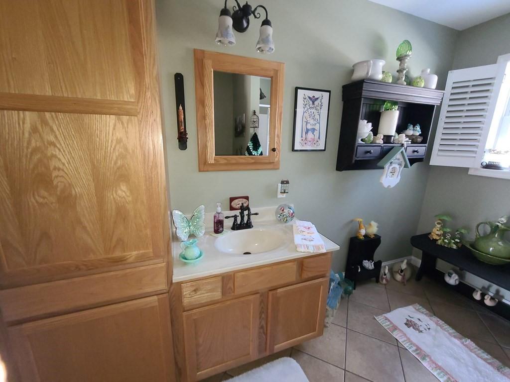 1101 Tin Town Road Sligo, PA 16255 - Photo 38 of 41 a bathroom with a sink mirror and vanity