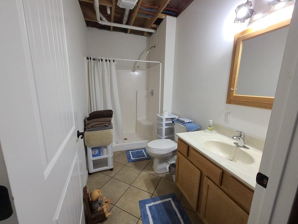 1101 Tin Town Road Sligo, PA 16255 - Photo 41 of 41 a bathroom with a sink a toilet and a mirror