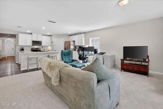 a view of a dining room with furniture and a livingroom